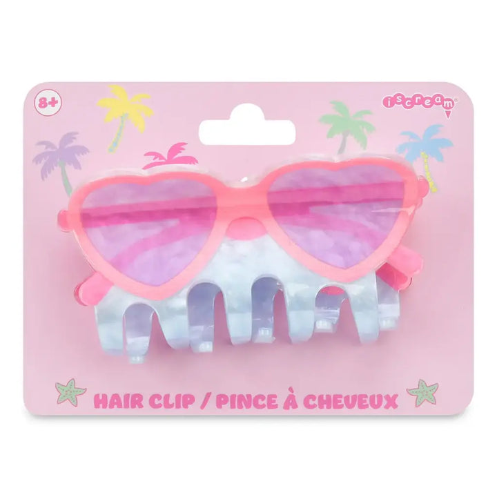 Heart-shaped hair clip with pink and purple design on a pink packaging background
