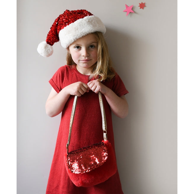 Little Girl modeling a red dress, santa hat and rockahula red sequin bag