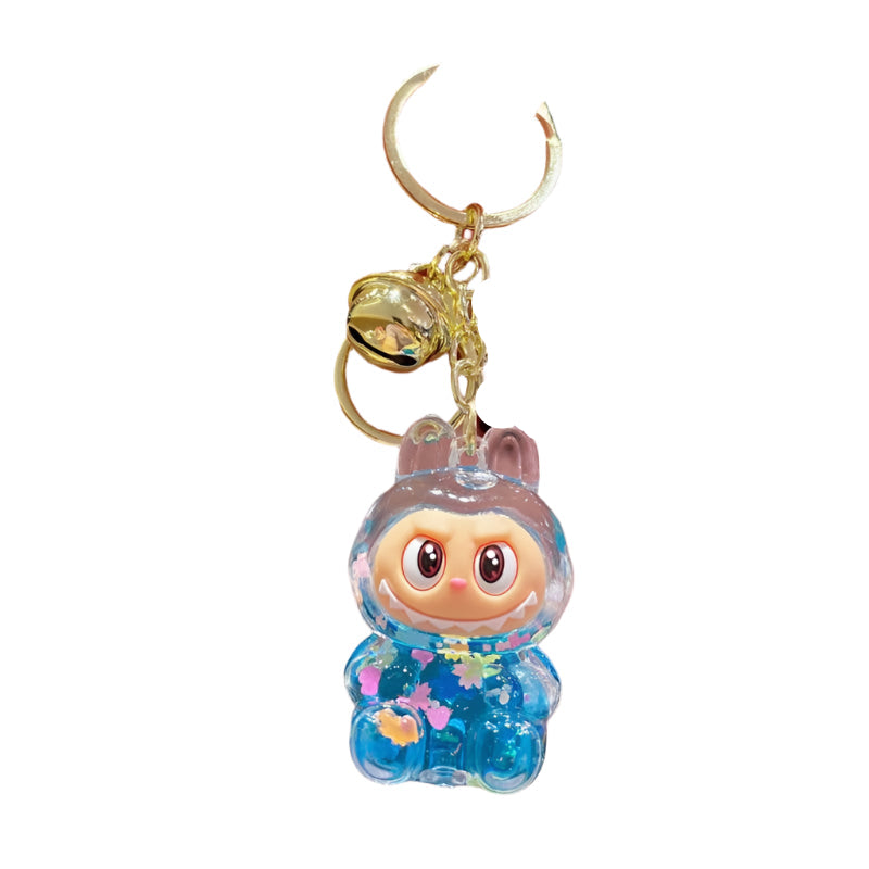 small labubu charachter in acrylic keychain with blue confetti inside the clear figure which moves when the figure is shaken. 