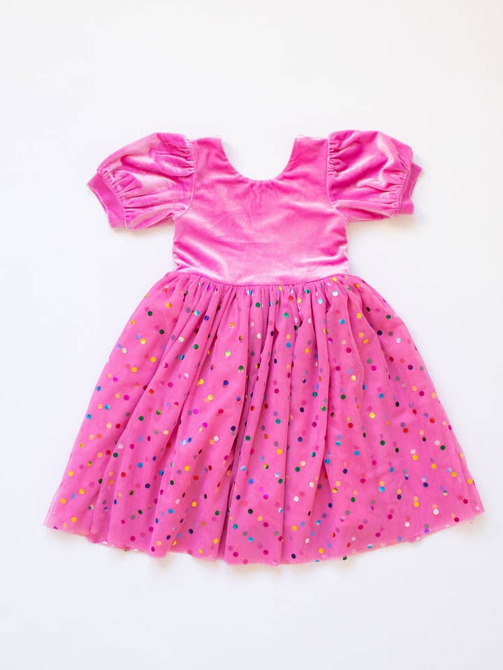 bubblegum pink velvet dress with tulle confetti bottom. the sleeves are a puff sleeve. 