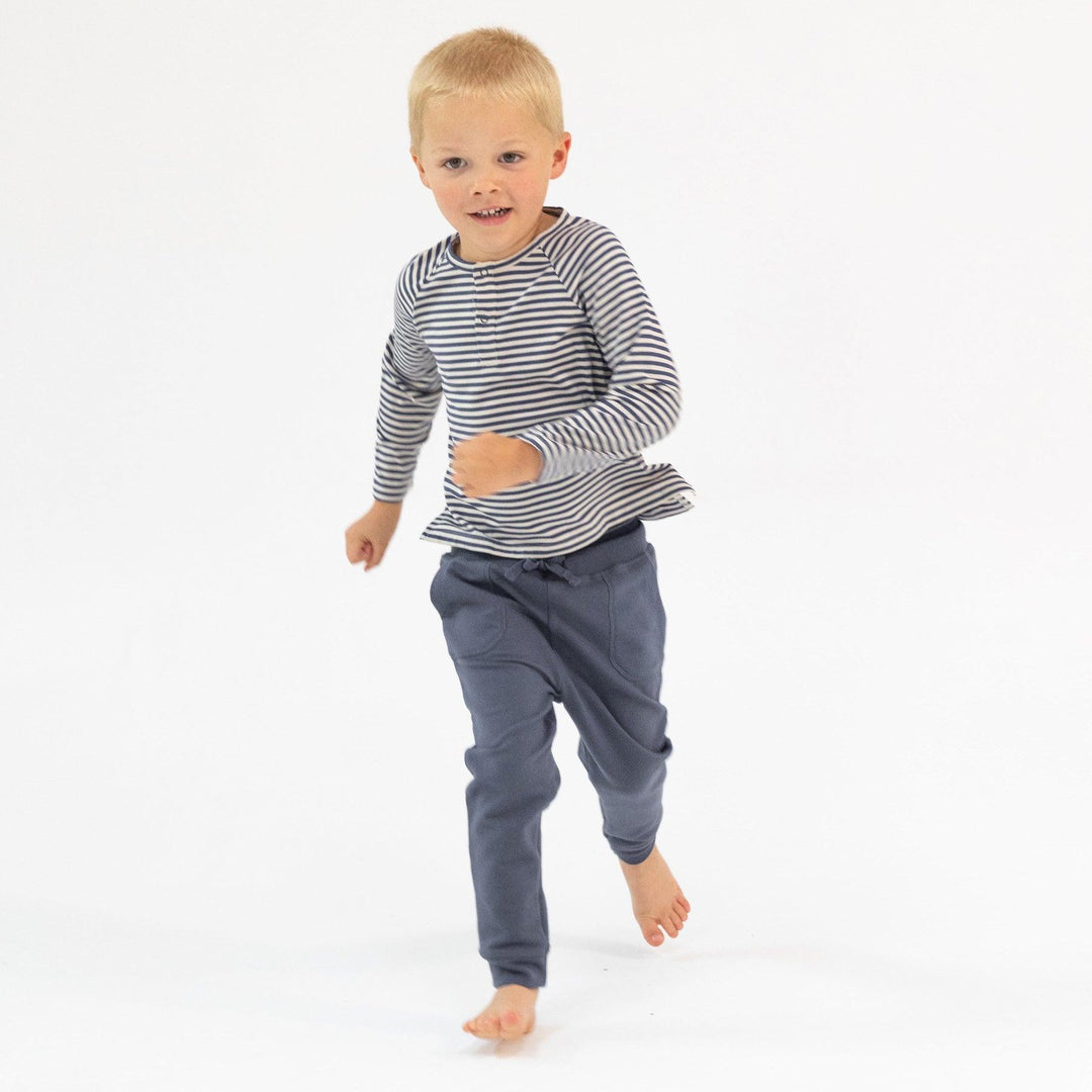 boy modeling a long sleeve striped tee, navy and oat stripe 