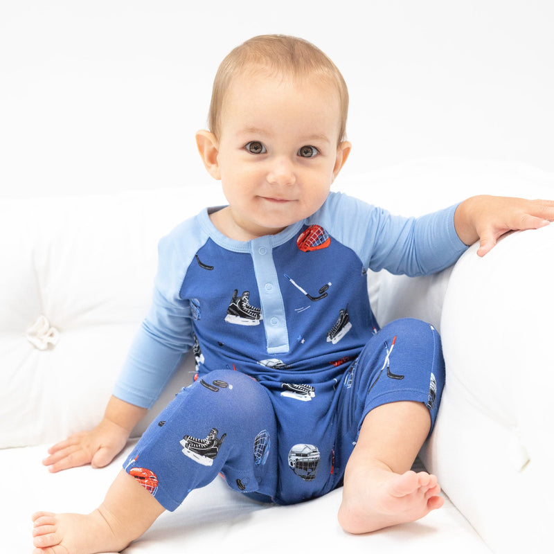 baby boy wearing the hockey one piece jumpsuit with raglan style sleeves. 