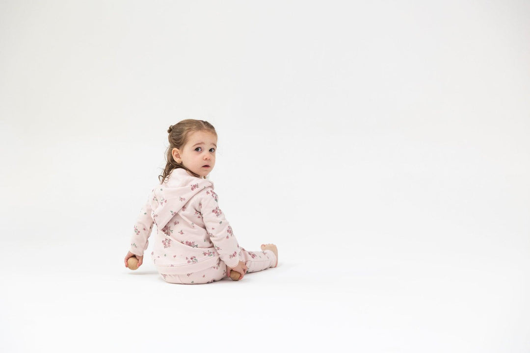 baby modeling the pink floral jogger set. 