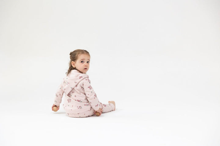 baby modeling the pink floral jogger set. 