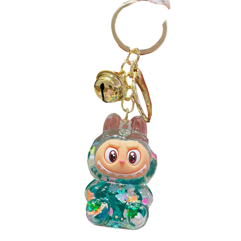 Labubu inspired keychain with dark green glitter confetti inside attached to a gold keyring. 