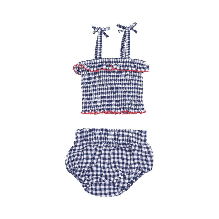 navy and white gingham top and bloomer set , the top has a ruffle and the top has red trim around the top and bottom. 