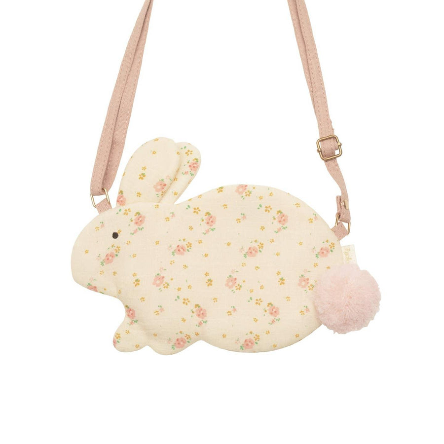 beige bunny bag with tiny pink flower print and a pink pom pom tail attached. pink crossbody strap attached. 