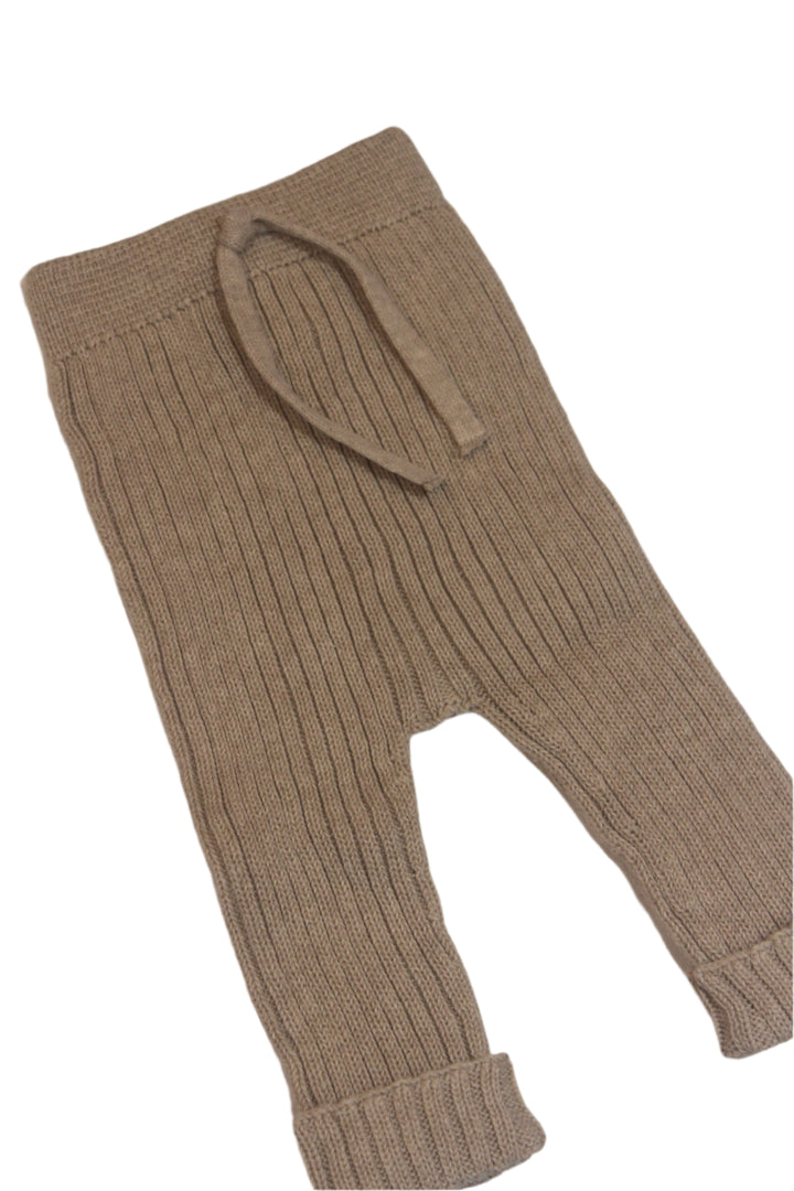 knit baby pants in toasted beige/light brown color. pants have a small cuff at the bottom of the pants. 