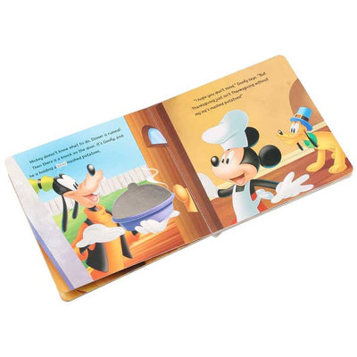 inside of the book showing Mickey and Goofy cooking turkey