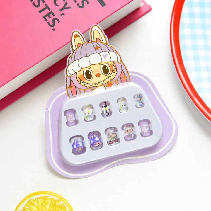 Set of small press on nails in a purple holder with a cute character on top, on a white surface.