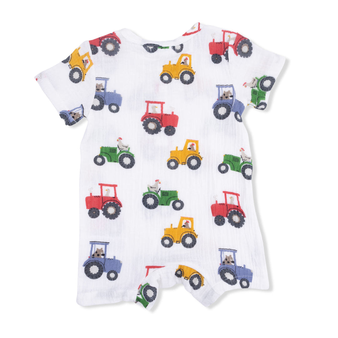 back of Baby romper with colorful tractor pattern on a white background