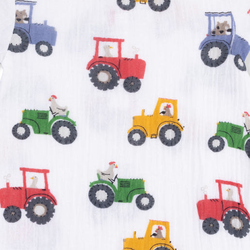 Baby romper with colorful tractor pattern on a white background