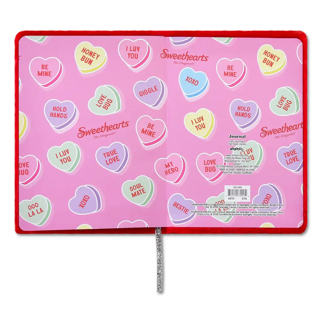 Pink journal with heart-shaped candy-themed stickers on a white background