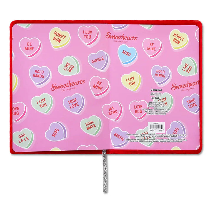 Pink journal with heart-shaped candy-themed stickers on a white background