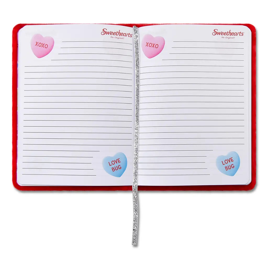 Open notebook with lined pages and decorative stickers on a white background