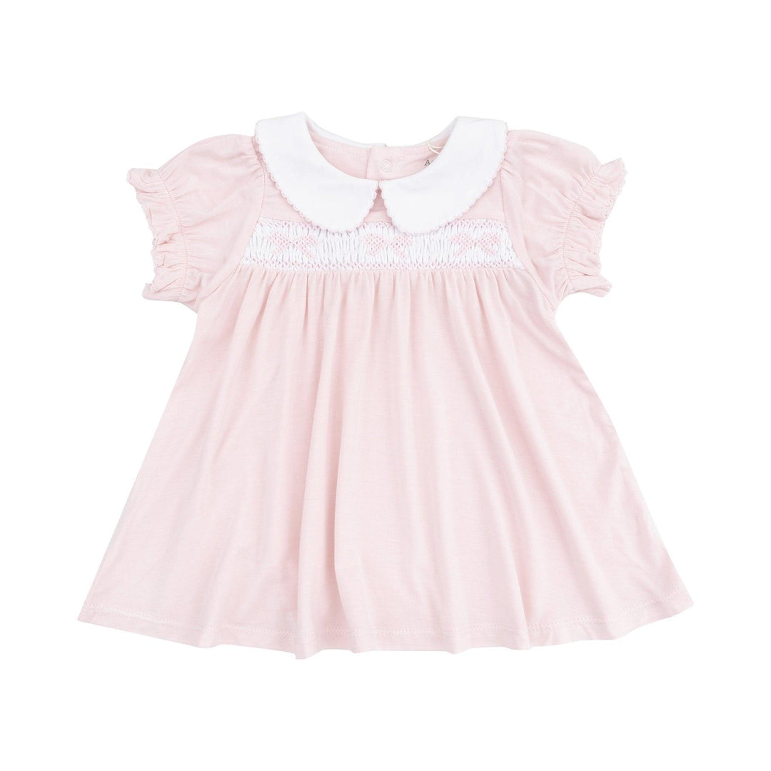 pink dress with peter pan collar and smocking on the chest with bows on the chest. 