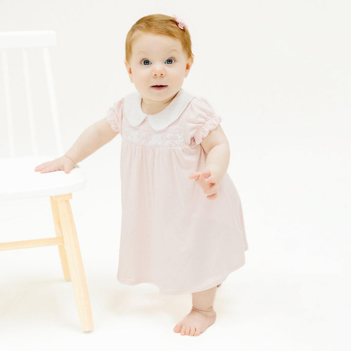 baby wearing peter pan collar pink dress 