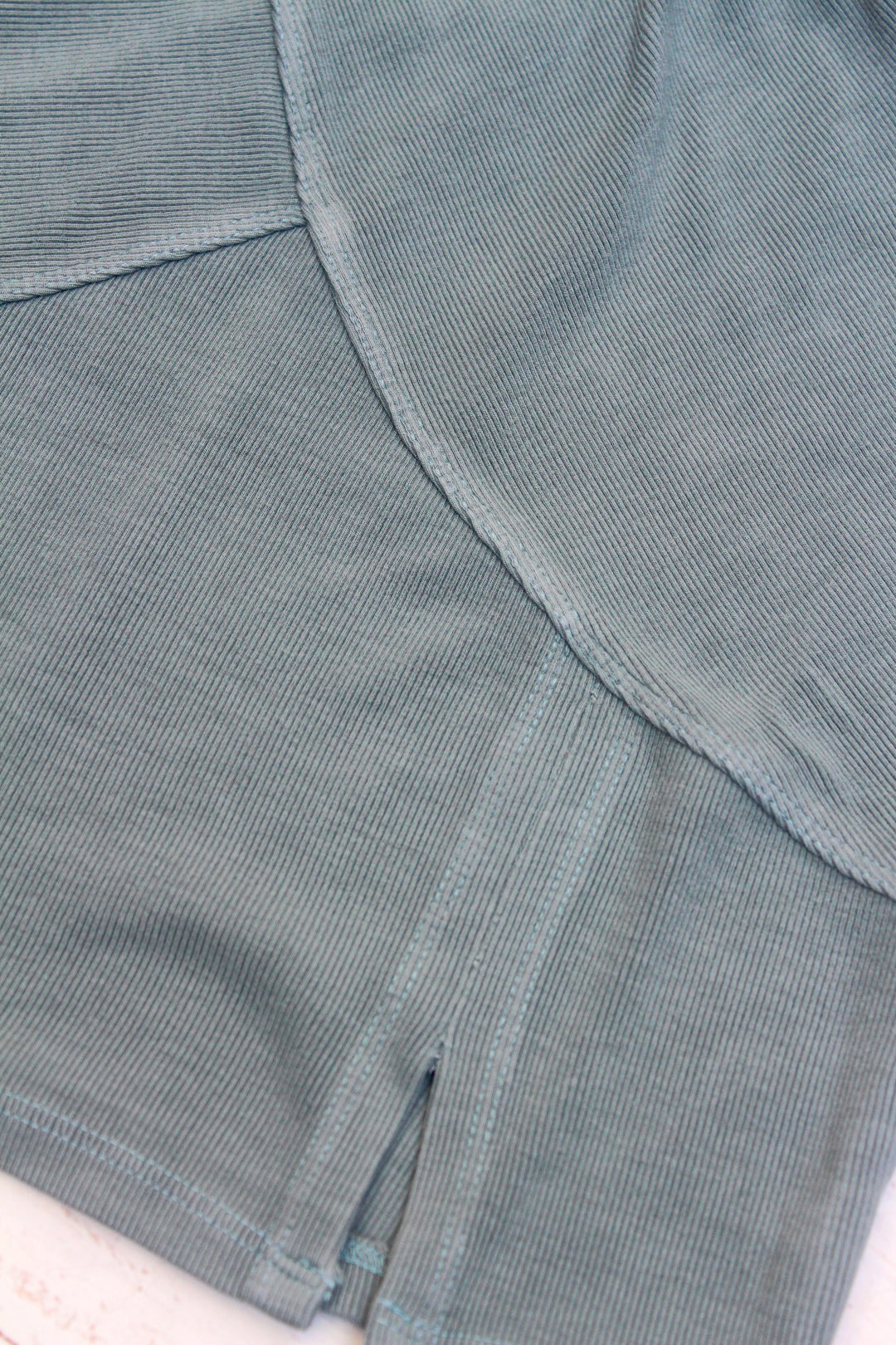 Close-up of a textured gray fabric with a visible seam.