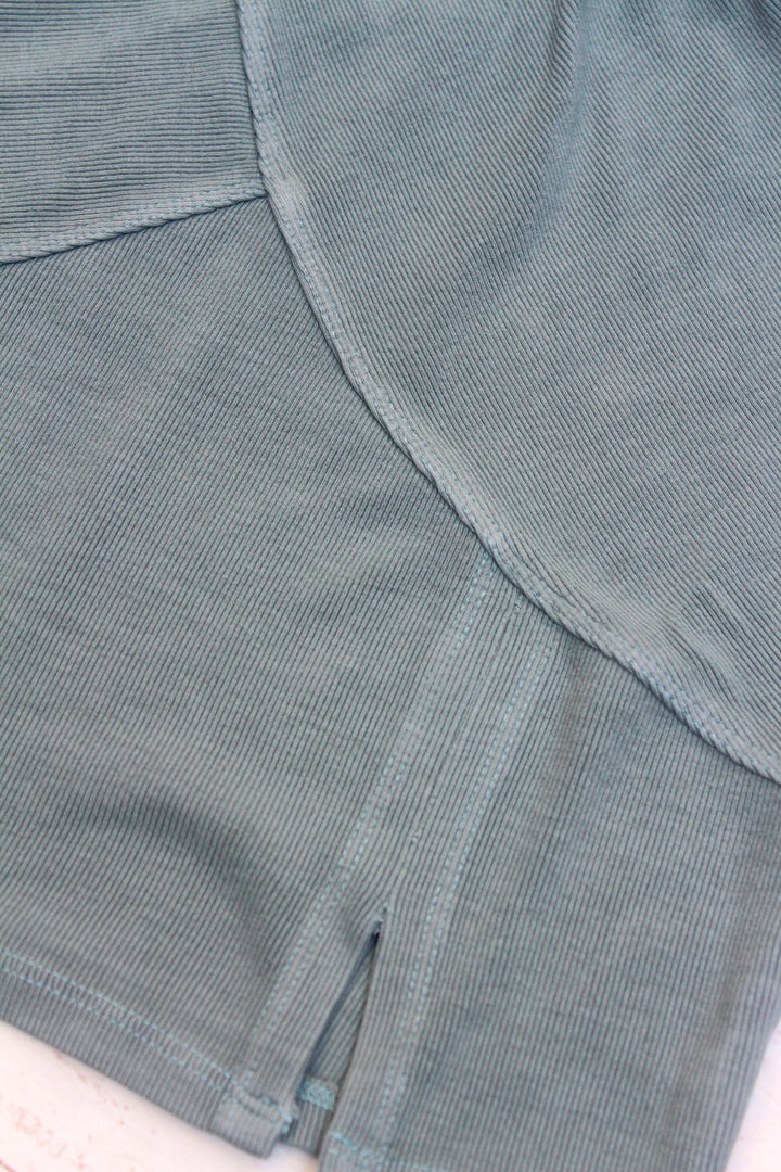 Close-up of a textured gray fabric with a visible seam.