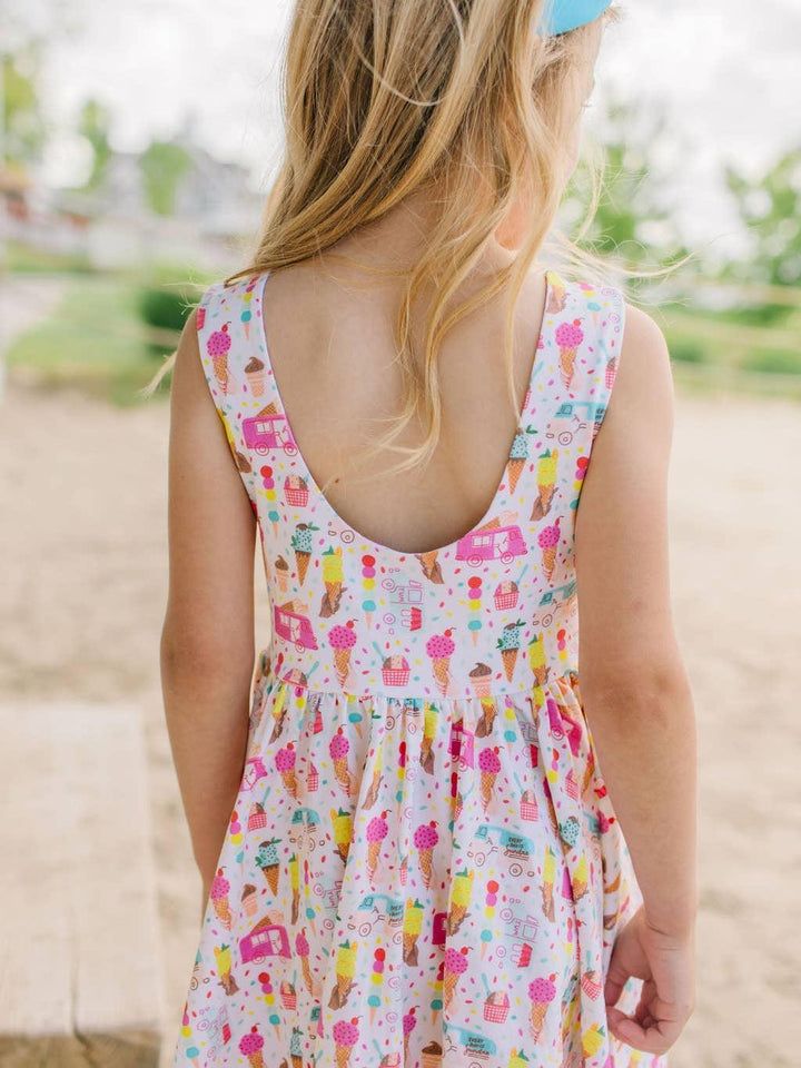 this picture shows the back of the tank dress and a close up of the colorful print: ice creams in pink, yellow and teal. 