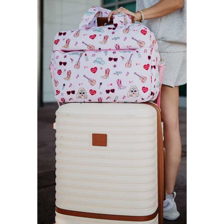 This shows The duffel bag on top of the luggage utilizing the slip pocket that the duffel has 