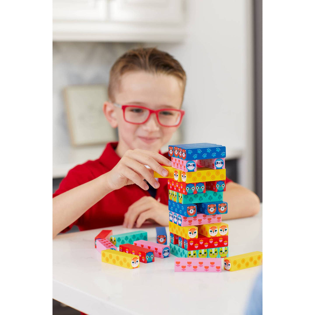 Child playing with colorful building blocks indoors