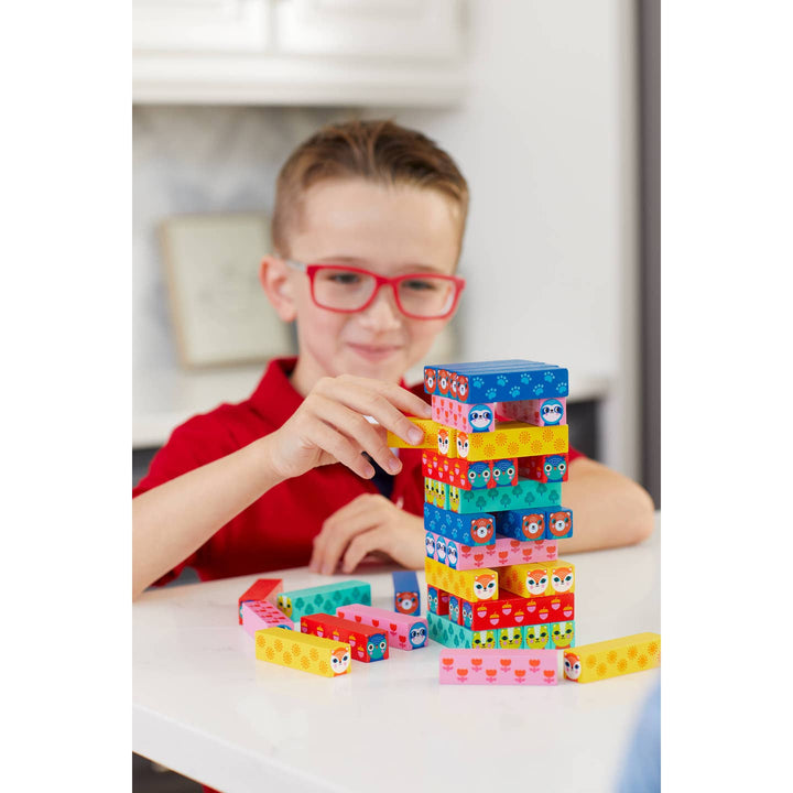 Child playing with colorful building blocks indoors
