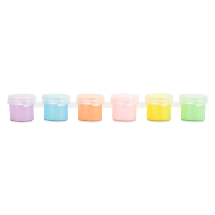 Six small plastic jars of colorful slime arranged in a row on a white background, featuring pastel shades of purple, blue, orange, pink, yellow, and green.