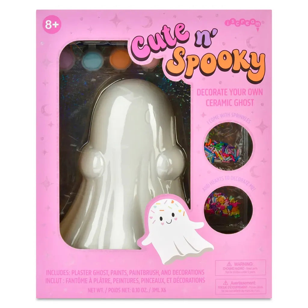 Cute 'n' Spooky ceramic ghost craft kit in its original pink packaging. The box features a clear window showing a white plastic ghost inside, with colorful paint splatters in the background.