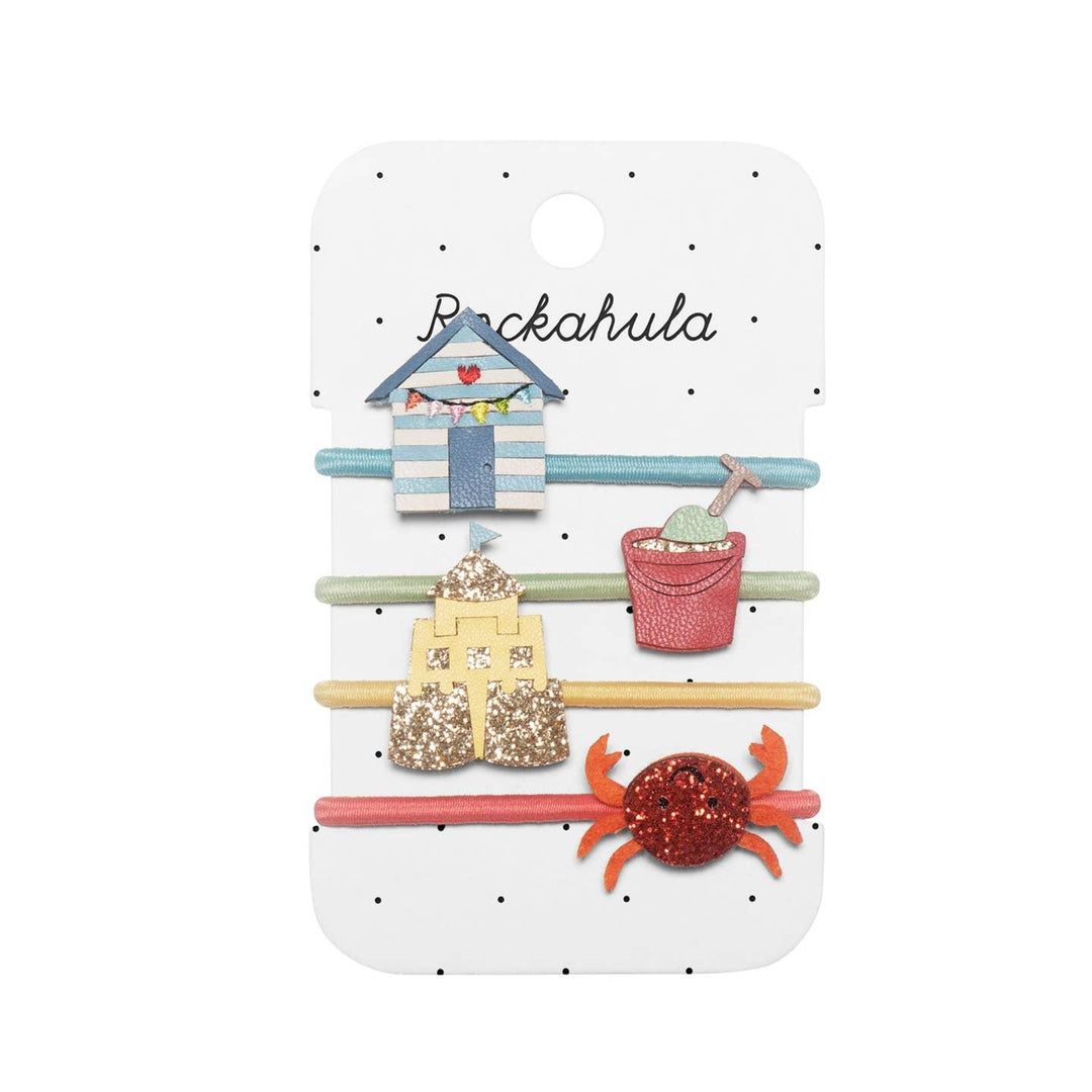 set of 4 ponies: one beach hut, sand castle, sand pale, and a red glitter crab