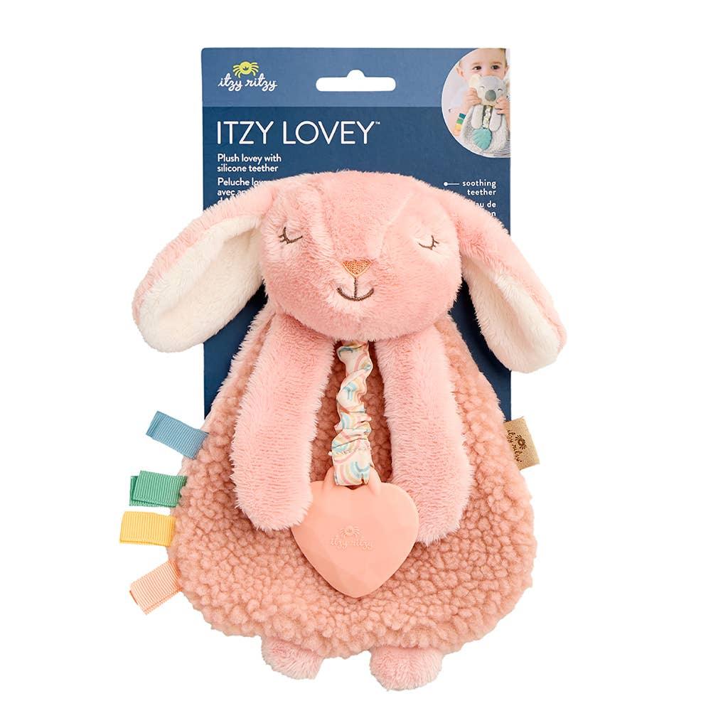 bunny attached to the vendor packaging with teether and ribbons attached. 