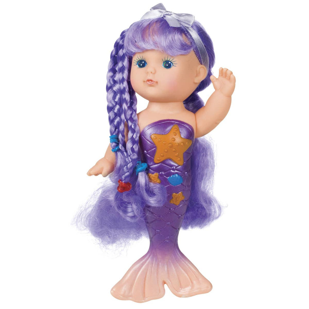 Mermaid doll with purple hair and tail on a white background