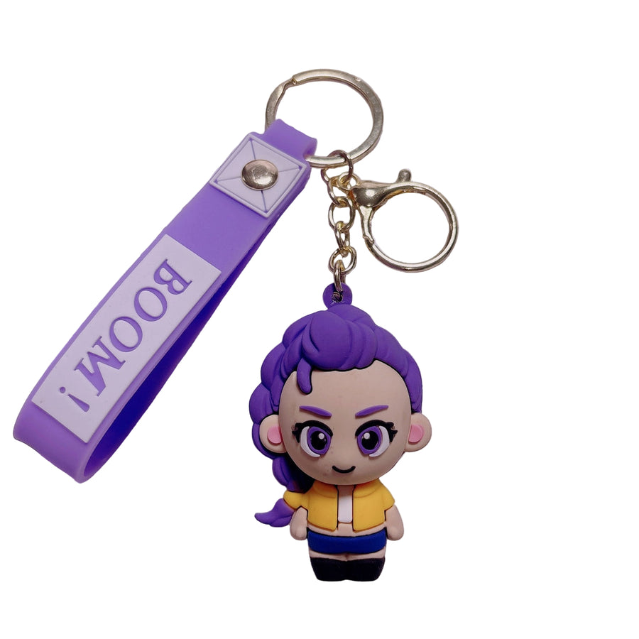 Keychain with  KPOP Demon Hunter's character and purple strap labeled 'BOOM!' on a keyboard background