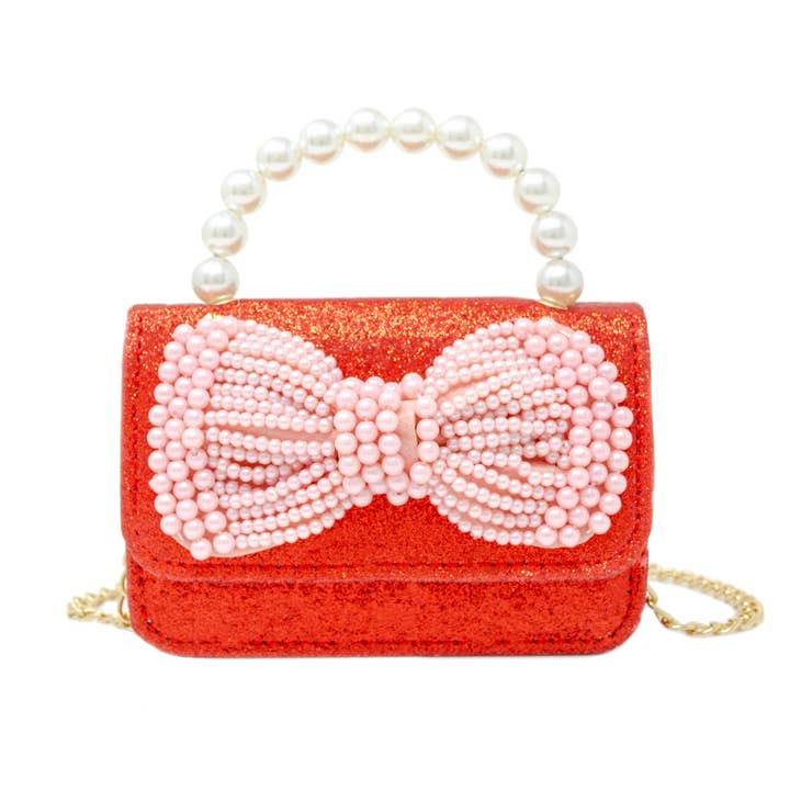 red glitter handbag with pink pearl bow and pearl handle on top and gold chain attached to the inside