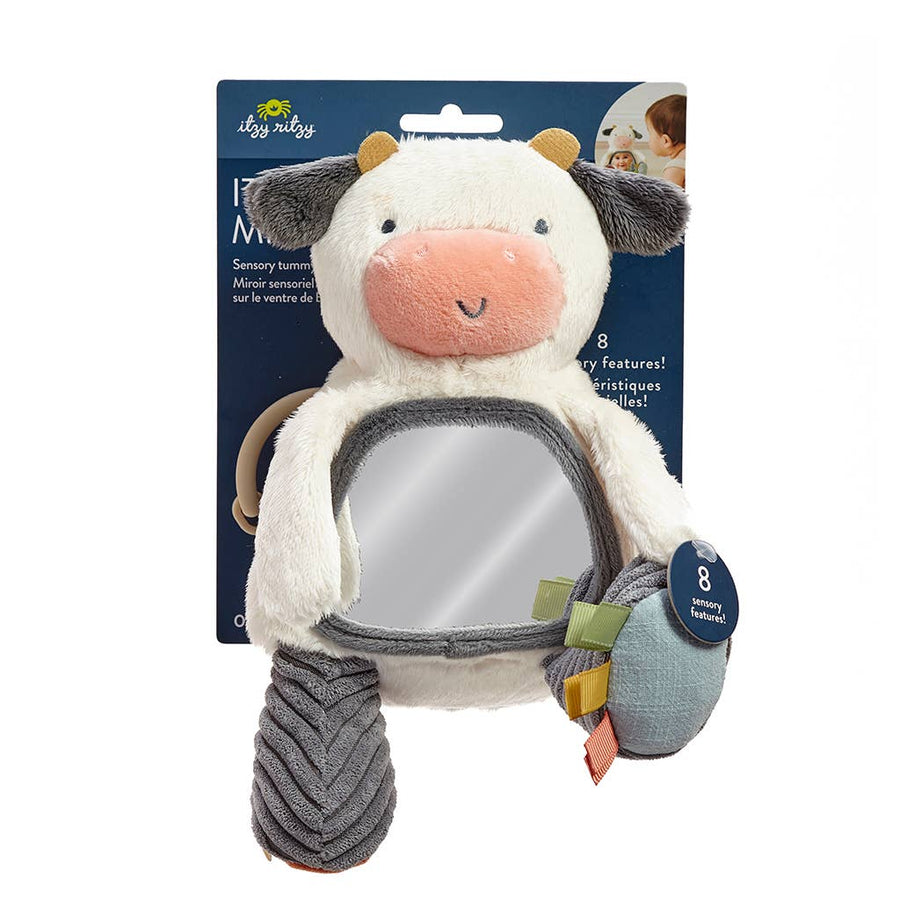 Plush toy cow with a mirror on a blue packaging background
