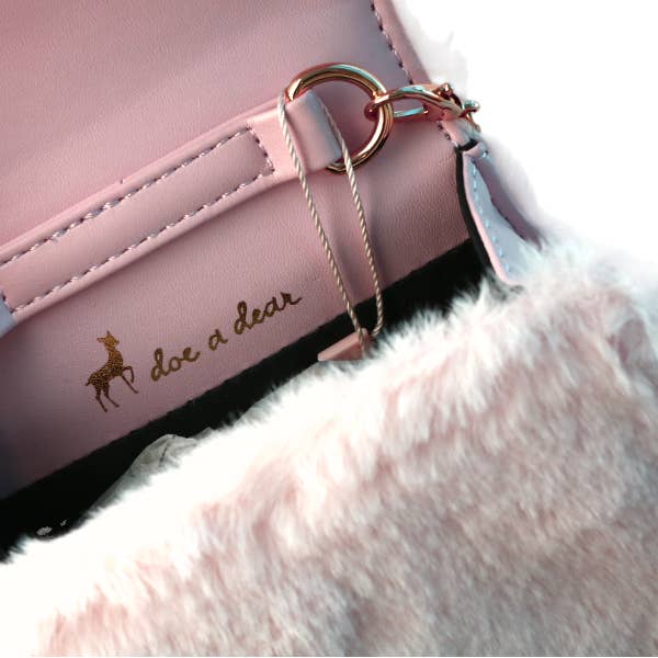 close up of the inside of the bag with doe a dear written inside and a small faux leather lining. 