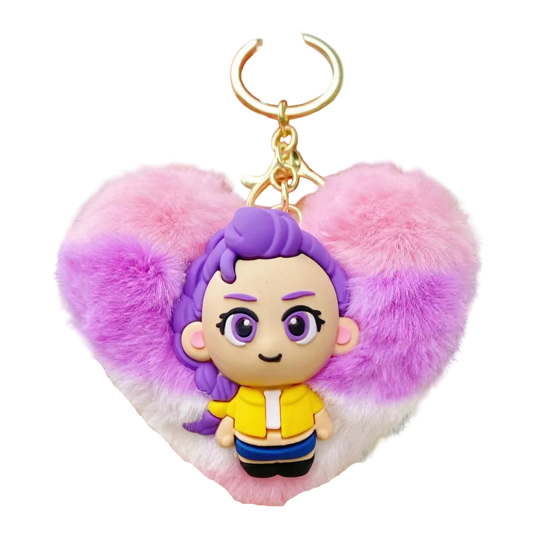 Keychain with a character in a yellow shirt and purple hair, surrounded by pink and purple fluffy heart-shaped material.
