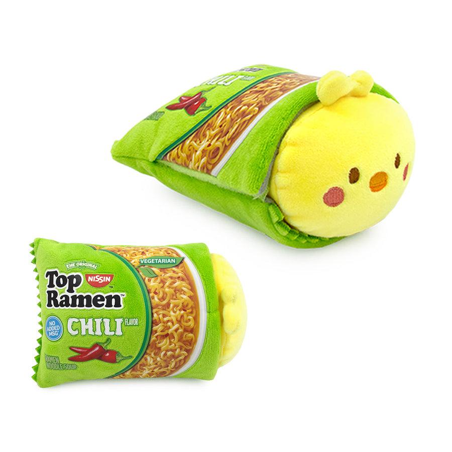 plush chicki laying in a Top Ramen package in the chili flavor. 