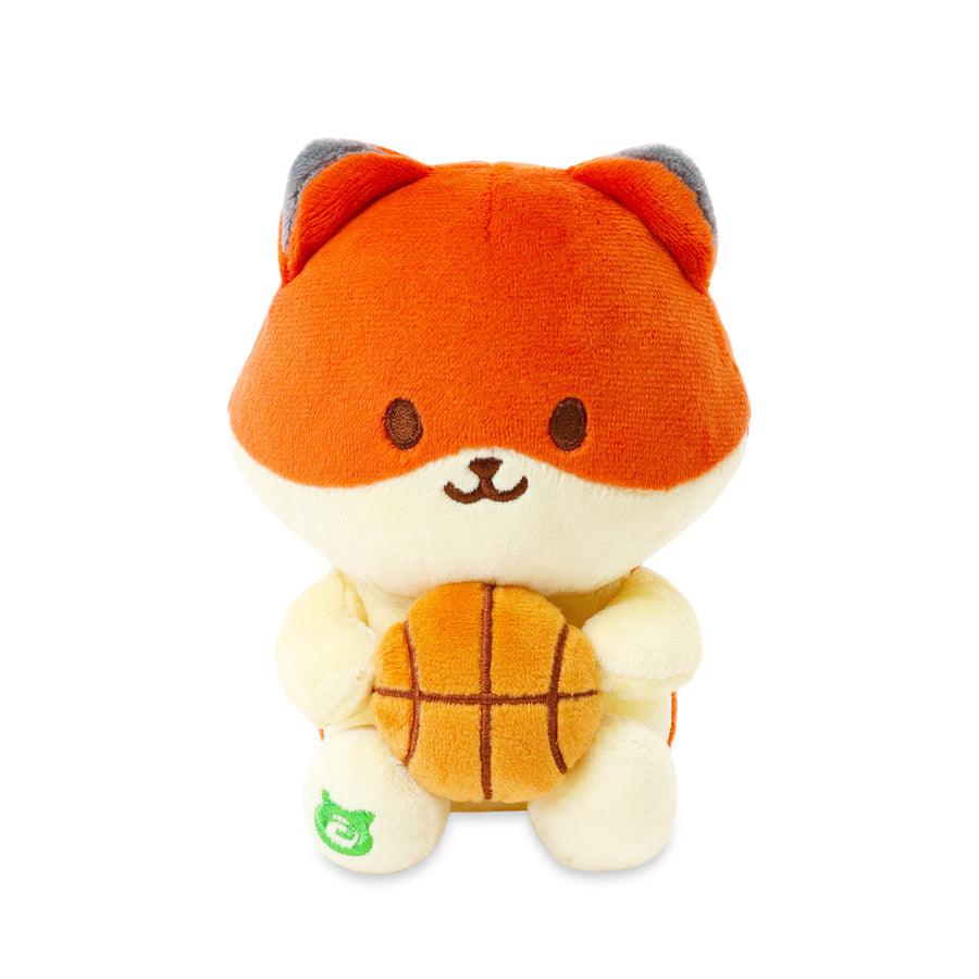 fox holding basketball and sitting down.