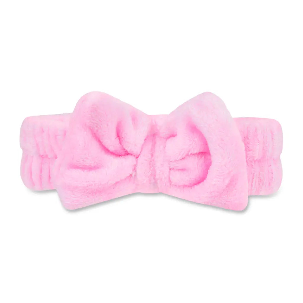 Pink headband with a large bow on a white background