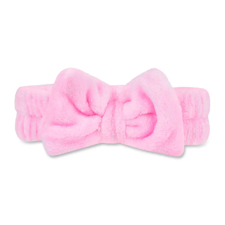 Pink headband with a large bow on a white background