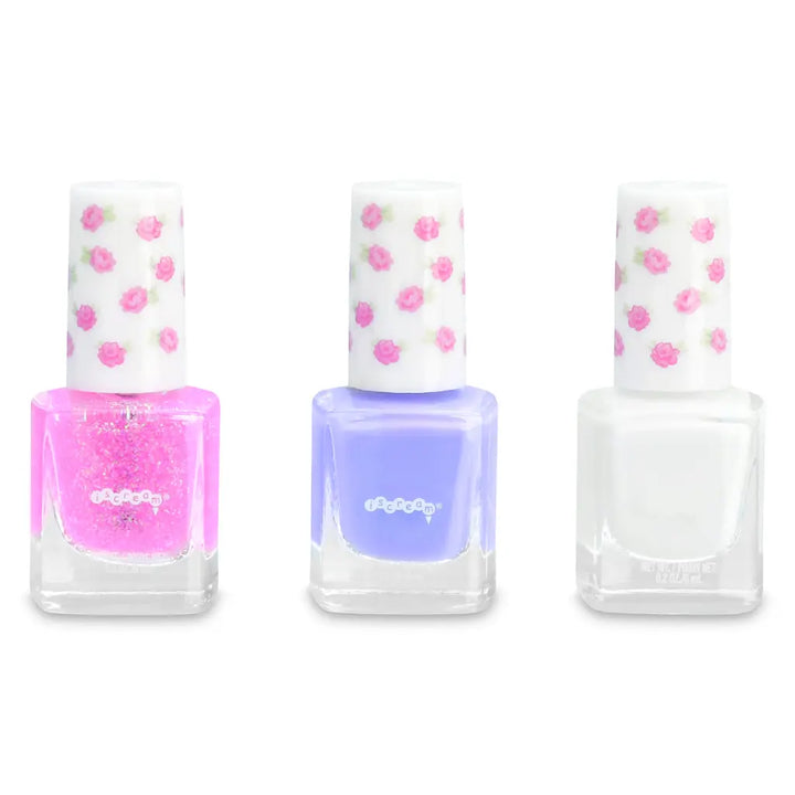 Three nail polish bottles: pink glitter, purple, white colors