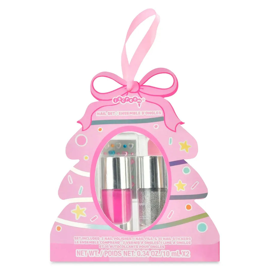 A pink holiday-themed nail set in a Christmas tree-shaped box with a hanging ribbon. The set includes a bright pink nail polish, a silver glitter nail polish, and a small tube of clear lip gloss, visible through a circular window in the front of the packaging.