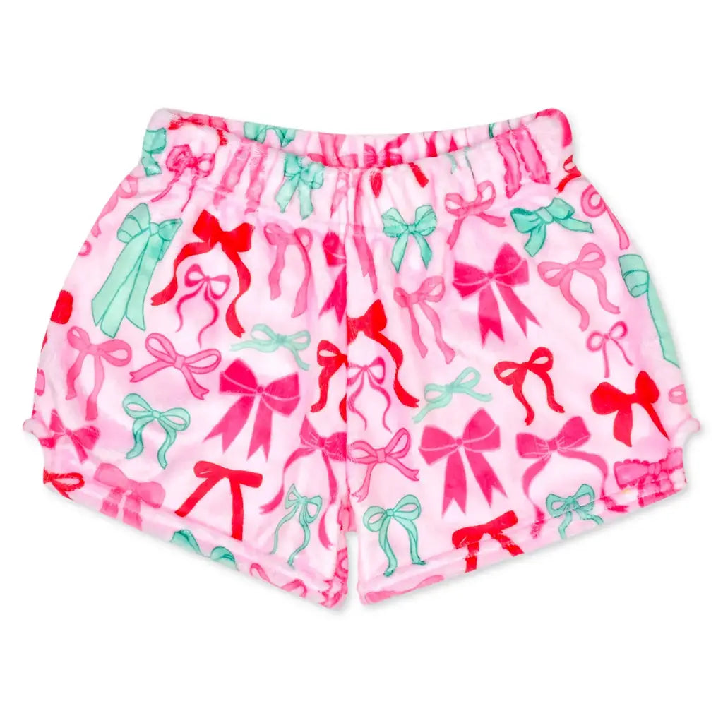 Pink shorts with an allover pattern of red and mint green bows, shown flat against a white background.