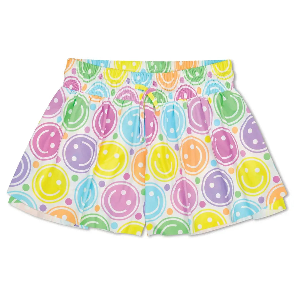 A pair of girls' shorts featuring a colorful watercolor smiley face pattern on a white background, complete with an elastic waistband and drawstring.