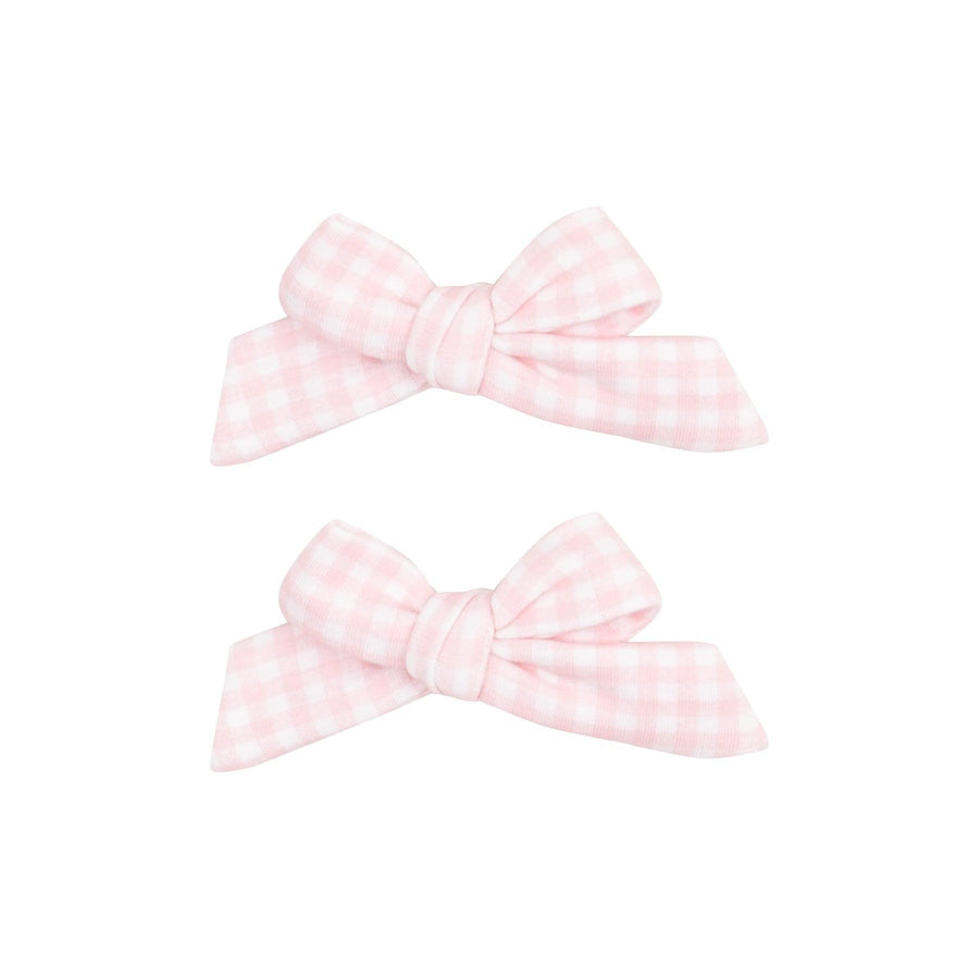 set of hair bow fastened to an alligator clip in pink and white gingham fabric. 