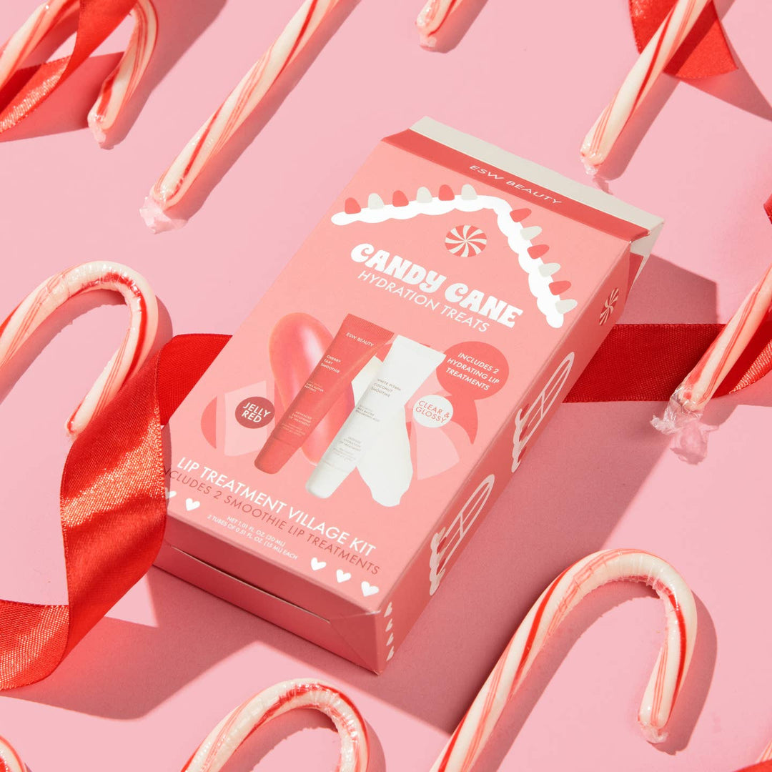 Candy Cane Lip Treatment Village Kit packaging on a pink background with candy canes.