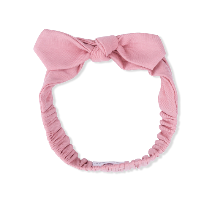 Pink headband with a bow on a white background