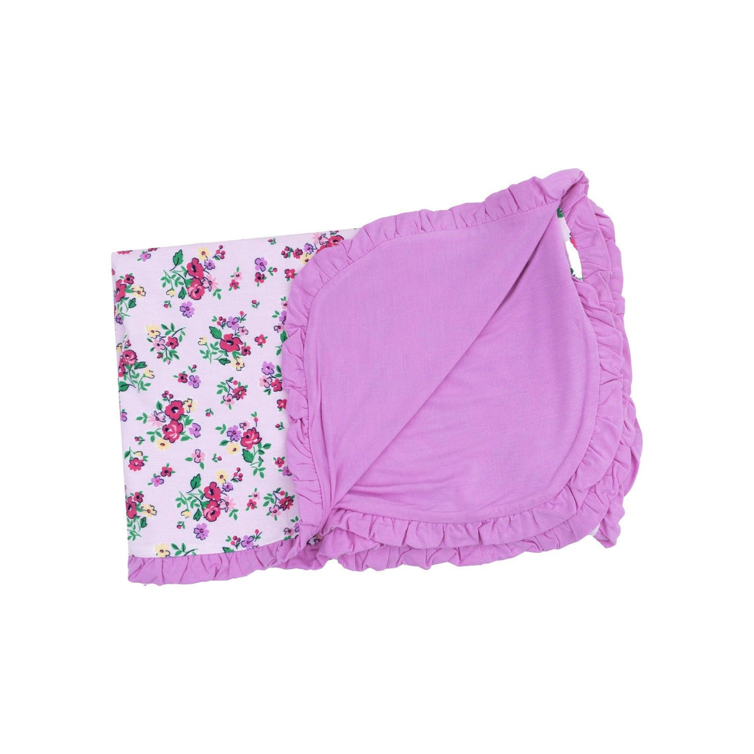 baby receiving blanket with solif purple on one side and lavender floral  with pops of jewel toned flowers on the other. 