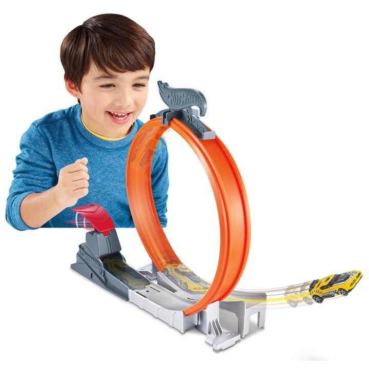 round race track in orange color where the car rides on top in a loop track 